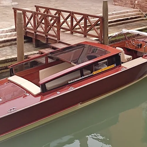 Wooden water taxi moored beside a Venice landing