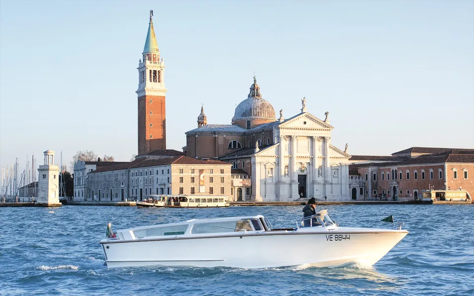 A water taxi crossing the lagoon near San Giorgio Maggiore