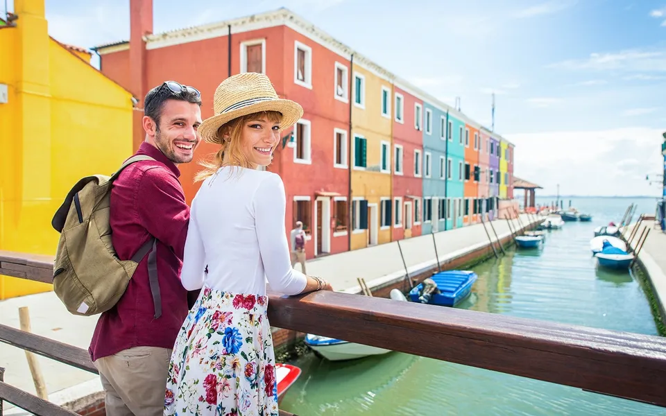 Visitors by a canal and colourful houses on Burano