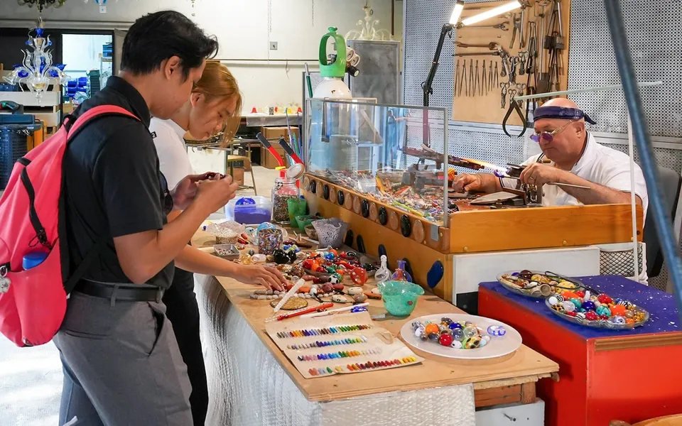 Glass objects being made and displayed in a Murano workshop