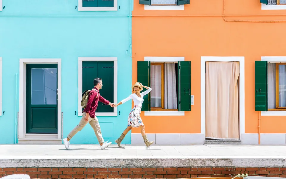 Visitors walking beside colourful houses on Burano
