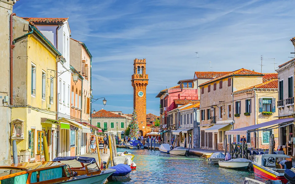 Colourful waterfront buildings and boats in Murano