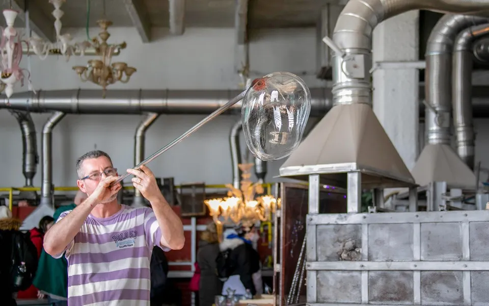 Glassblower shaping molten glass in a Murano workshop